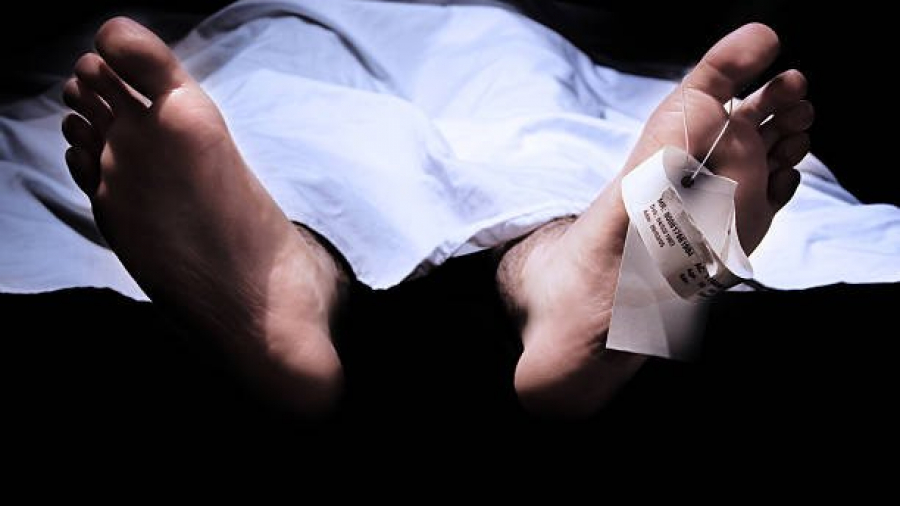 Conceptual shot of feet with a hospital information ring and tag representing death