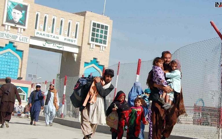 Afghan citizens at a border checkpoint with Pakistani security forces