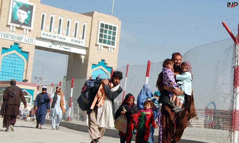 Afghan citizens at a border checkpoint with Pakistani security forces